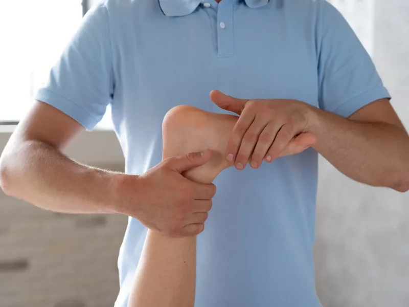 Clinician examining a patient&rsquo;s foot for nerve-related symptoms