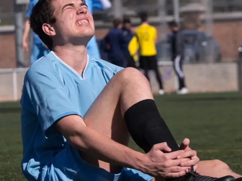 Athletic trainer attending to an injured player on the field