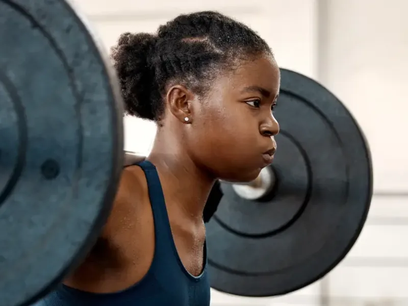 Lifter setting up under a loaded barbell