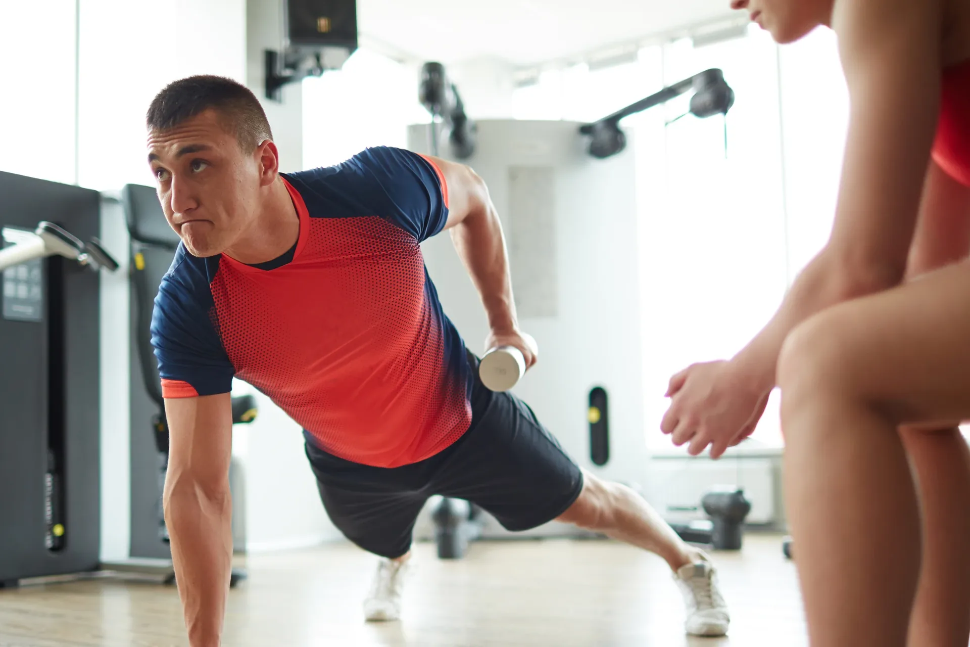 Physical therapist coaching an athlete through a lunge at On Point Movement & Performance in Richardson