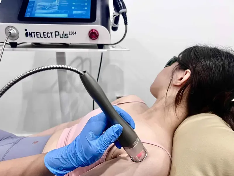 Laser therapy being applied to a patient's neck and shoulder
