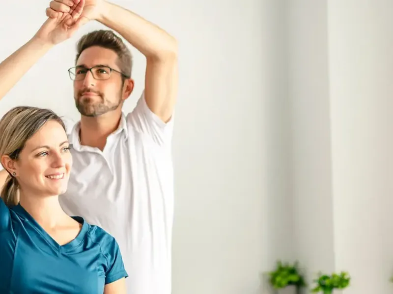 Therapist running a patient through a movement screen