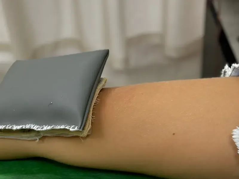 PEMF therapy applicator placed over a patient's leg