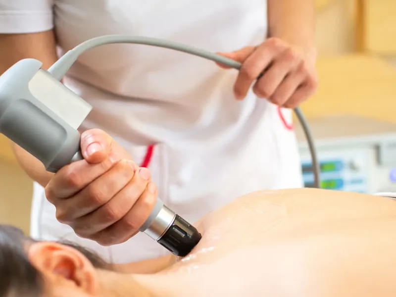 Shockwave therapy applicator being used on a patient