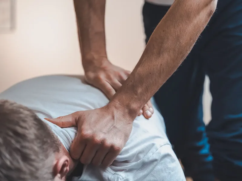 Therapist performing a spinal mobilization