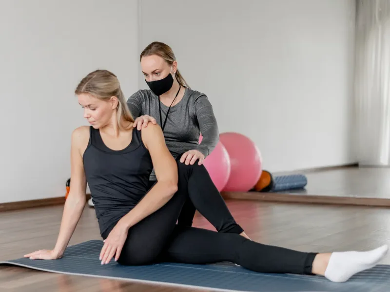 Therapist guiding a patient through a vestibular treatment position