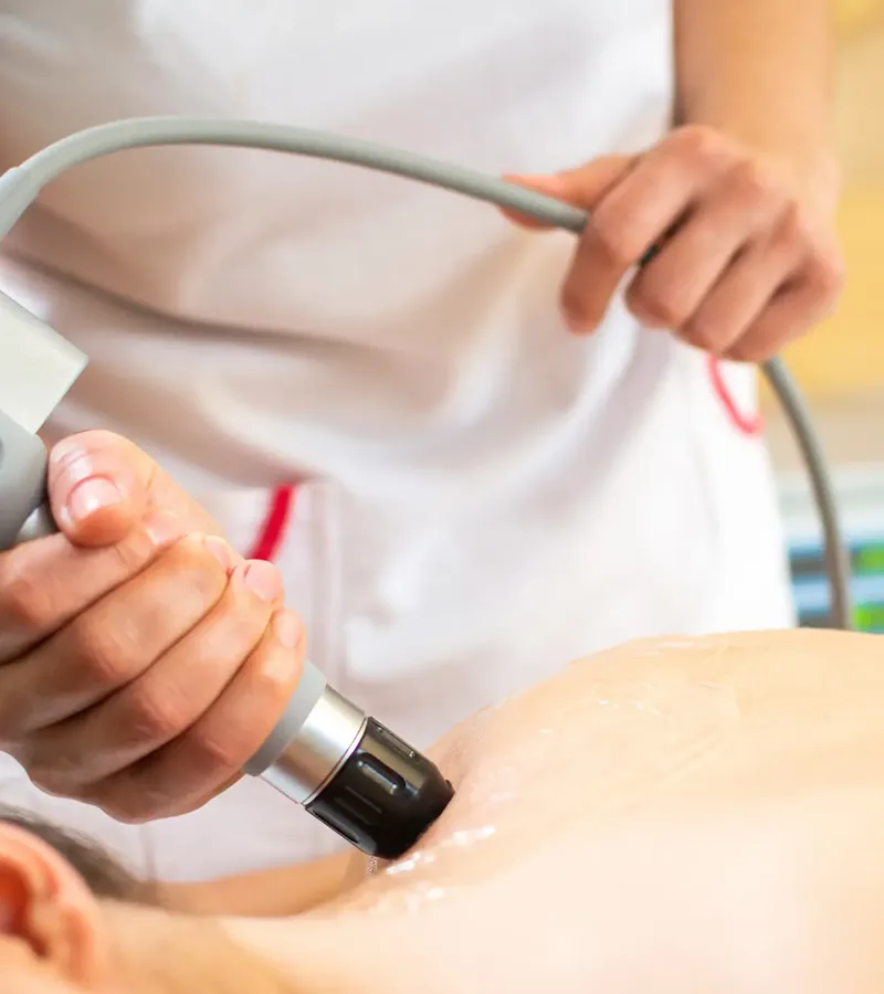 Shockwave therapy applicator being used on a patient