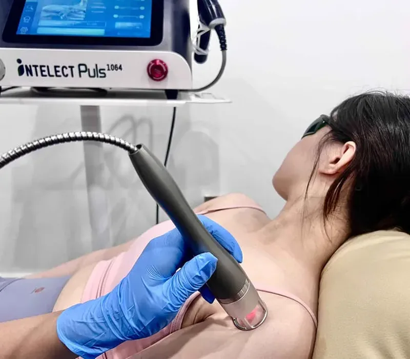 Laser therapy being applied to a patient's neck and shoulder