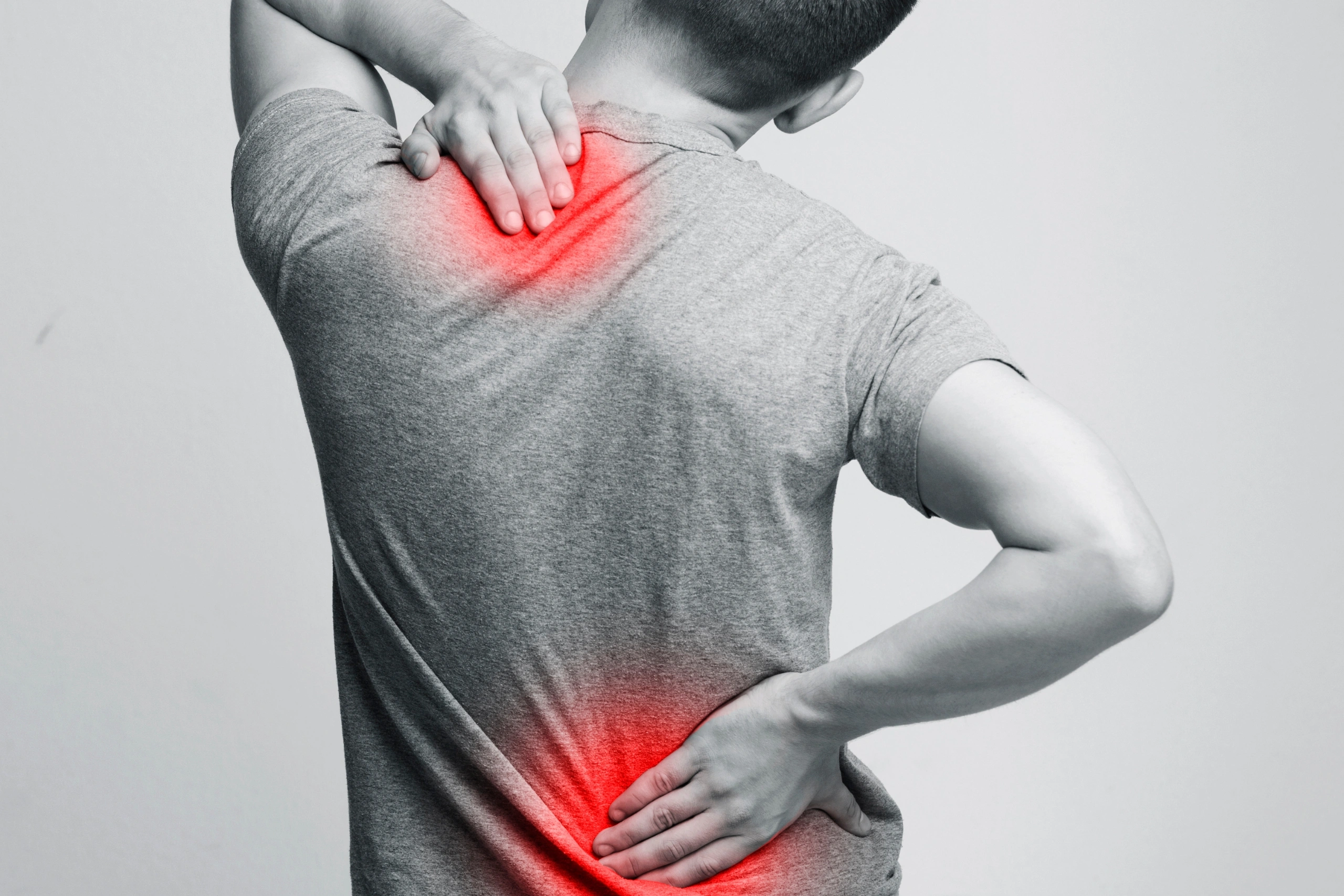 Man with neck and back pain, rubbing his painful body